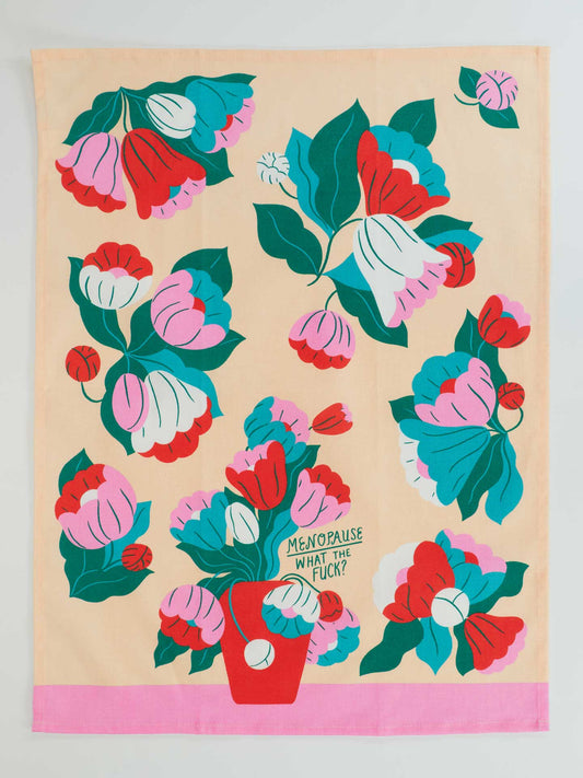 Brighten your kitchen with Blue Q’s “Menopause. What The Fuck?” dish towel, featuring vibrant flowers and a cheeky sign for a humorous touch while handling kitchen messes.