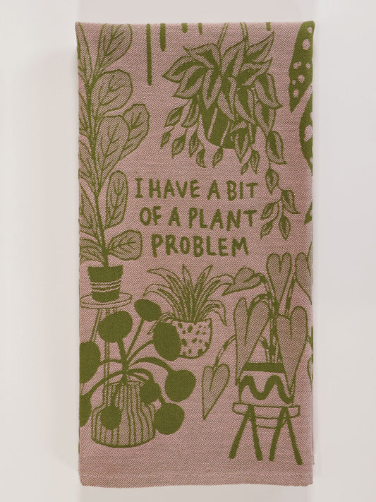 The Blue Q "I Have A Bit Of A Plant Problem" Dish Towel features green potted plant illustrations and bold text on a pink background—an ideal, charming accent for your kitchen or home decor.