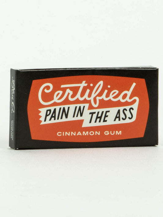 A black and red box of Blue Q's Certified Pain In The Ass Gum, featuring the product name in bold white and black letters on the front.