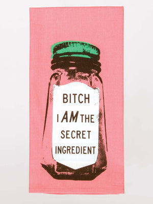 The Blue Q Bitch I Am The Secret Ingredient Dish Towel is a pink kitchen towel with a jar graphic and bold text, adding playful humor to your kitchen décor.