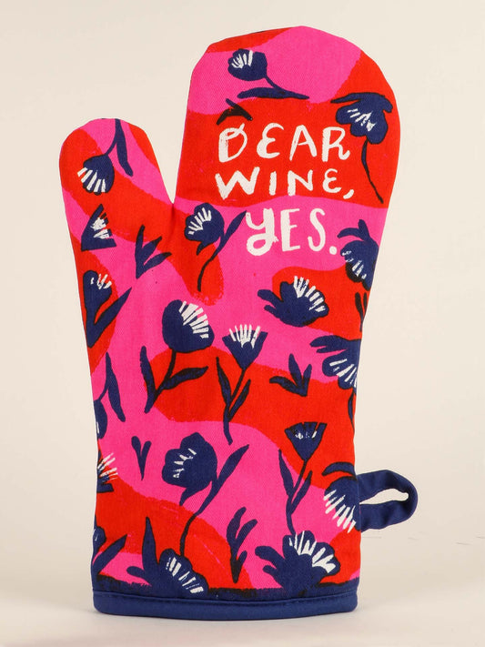 The Blue Q Dear Wine, Yes. Oven Mitt features pink and red colors, blue and white flowers, wine glasses, and the phrase “DEAR WINE, YES.” in white text—a charming romantic gift.