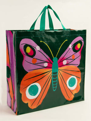 The Blue Q Big Butterfly Shopper is a spacious 6.2-gallon reusable bag with green handles, featuring a vibrant butterfly graphic on a dark green background—perfect for stylish shopping or carrying your essentials.