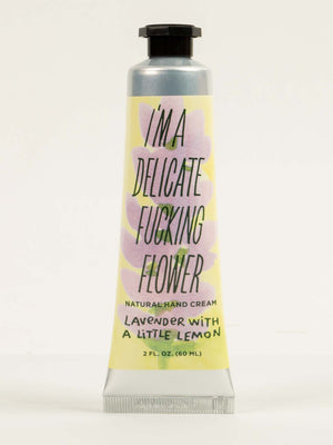 Blue Q’s “I’m a Delicate Fucking Flower” Natural Hand Cream—lavender with a little lemon—comes in a 2 fl. oz. tube featuring pastel colors and bold, playful text on the label.