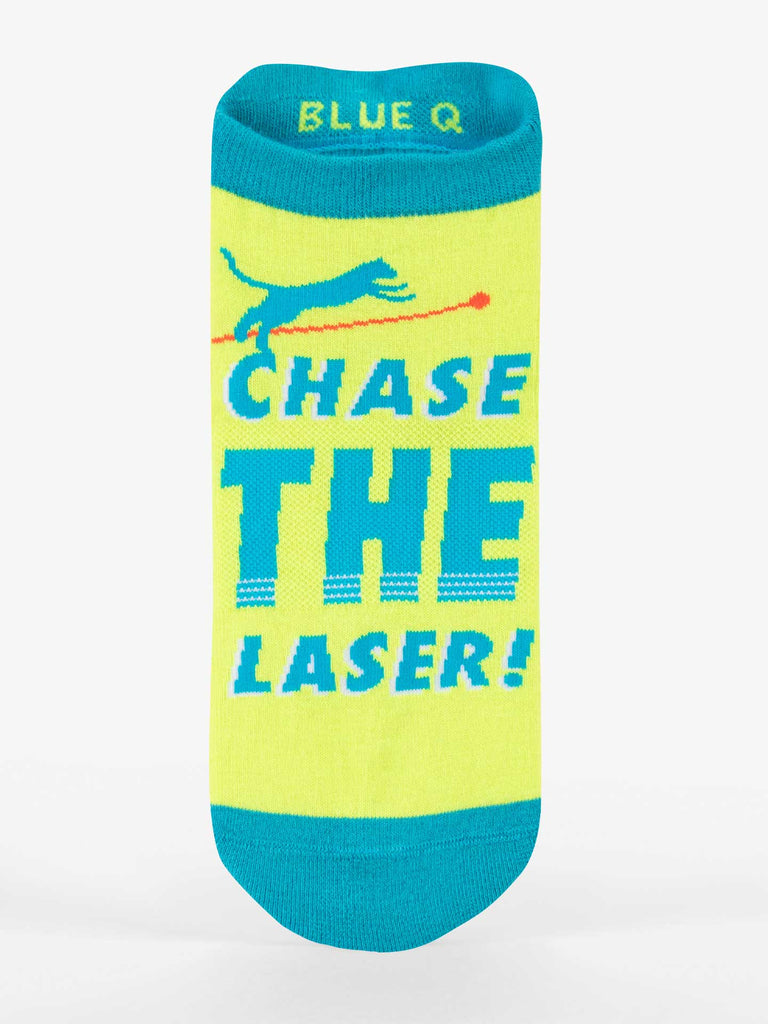The Blue Q Fun For All Sale Pack includes a yellow men’s crew sock with teal accents, a playful cat chasing a red laser, and “CHASE THE LASER!” in bold blue—perfect for a gift bundle.