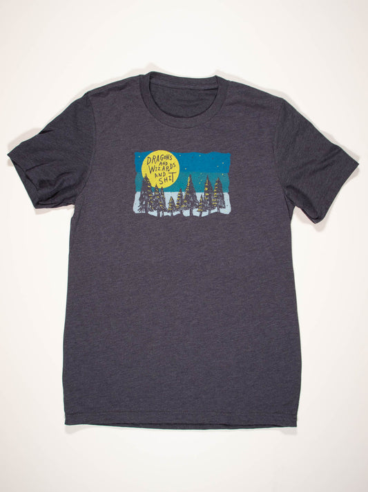 The Blue Q Dragons And Wizards And Shit T-Shirt is a dark gray tee with a pine trees and moon print, plus "DRAGONS, WIZARDS, and OTHER SH*T" text. Made from soft Airlume combed cotton. Check the unisex size chart for best fit.