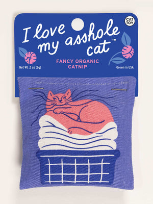 The Blue Q "I Love My Asshole Cat" Catnip Toy comes in a blue package with white text, featuring an orange cat on towels in a laundry basket. It contains organic catnip to encourage healthy play.
