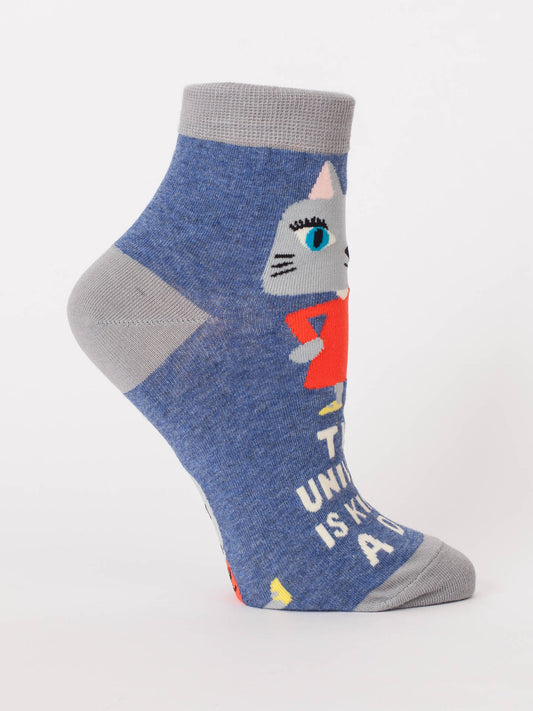 Blue Q's “The Universe Is A Kind Of A Dick” W-Ankle Socks feature blue and gray kitten designs with partial text and a blue-eyed kitten in a red dress.