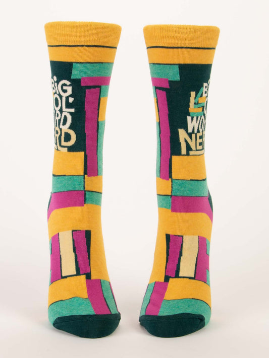 Bright geometric-patterned Big Ol' Word Nerd W-Crew Socks by Blue Q, in yellow, green, pink, and teal. Made with soft combed cotton and stretchy spandex. "BIG WORD NERD" appears in white near the top on a plain white background.