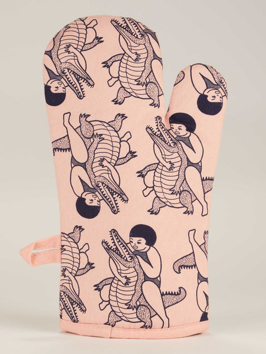 The Blue Q "Do One Thing Every Day That Scares Your Family" Oven Mitt features playful cartoon kids wrestling crocodiles in dark blue, making it the perfect fun and quirky addition to your Halloween kitchen or for a lighthearted prank.