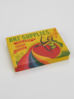 A colorful, compact Art Supplies Pocket Box by Blue Q features retro-style artwork of a person shooting a bow to create a rainbow, with the phrase “Feed your creative juices” on a yellow background with red and green accents.