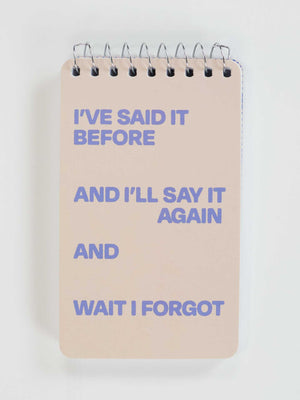 A 3x5 spiral notebook by Blue Q with a beige cover and purple text: "I've Said It Before And I'll Say It Again And Wait I Forgot.