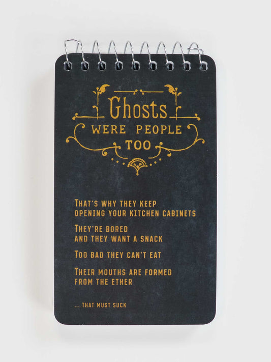 The Blue Q "Ghosts Were People Too" 3x5 spiral notebook features gold text on black and is perfect for notes, reminding you that ghosts were people too—maybe that's why they open your cabinets looking for snacks!.