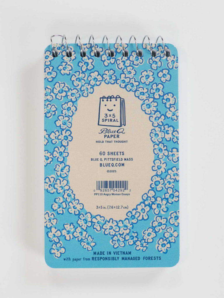 The Blue Q Angry Woman Essays 3x5 Spiral Notebook features a blue floral cover and center label stating “Blue Q Paper,” “60 sheets,” and “Made in Vietnam”—perfect for your desk or as a gift.