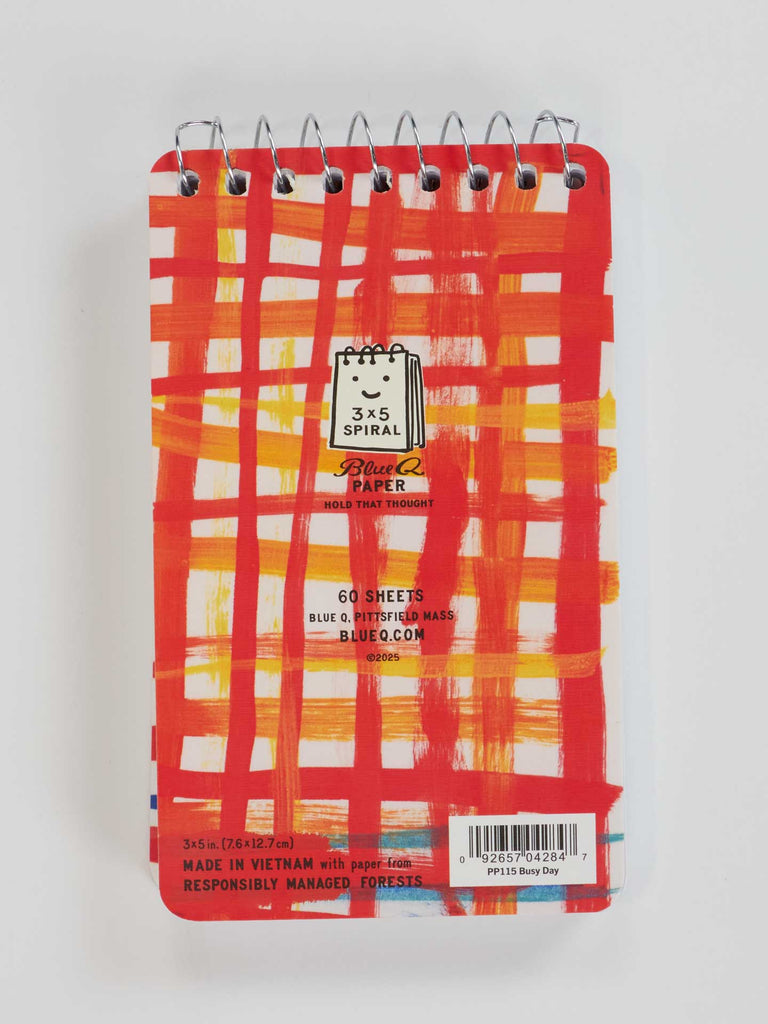 A small 3"x5" Blue Q spiral notebook with a red and orange grid cover, featuring "Preparing For A Busy Day Of Fighting My Mind" and product details on a white background.