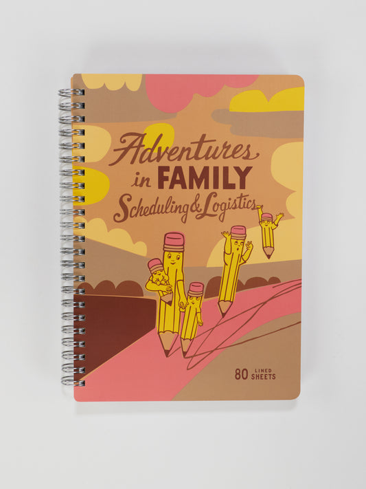 The Blue Q Adventures In Family Scheduling & Logistics 6x8 Spiral Notebook features a vibrant cover with cartoon pencil characters on an adventure and includes 80 lined sheets.