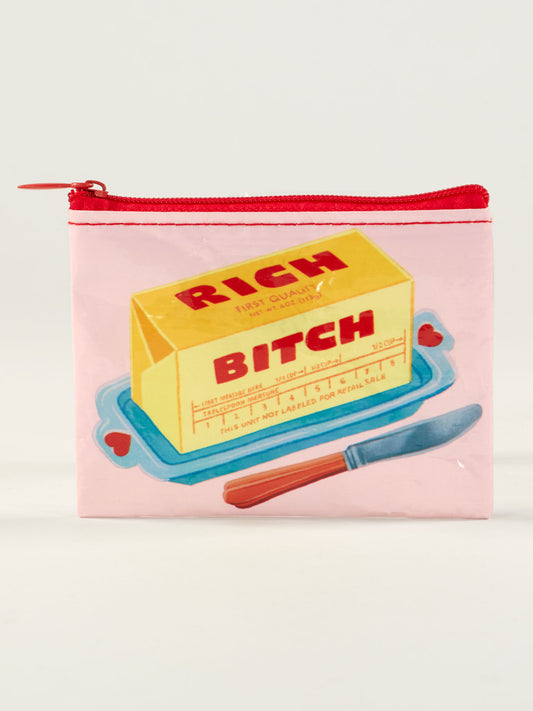 The Rich Bitch Coin Purse by Blue Q is a small pink zippered pouch with a butter stick illustration labeled "RICH BITCH" on a blue dish—perfect as a unique present or quirky gift idea.
