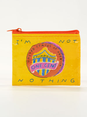 The Blue Q "I'm Not Nothing Coin Purse" is a small yellow pouch with a U.S. penny graphic and the phrase IM NOT NOTHING, bringing bold statement tee attitude to a fun, zippered accessory.