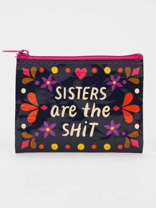 The Blue Q Sisters Are The Shit Coin Purse is a small zippered pouch featuring colorful floral designs and the phrase "Sisters are the shit" on the front, making this eco-friendly wallet a perfect gift for sisters.