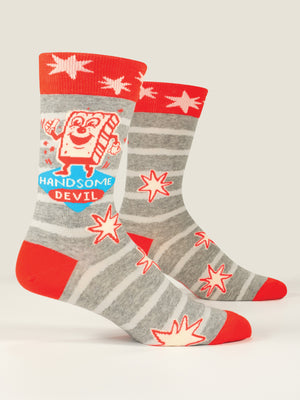 Blue Q’s Handsome Devil M-Crew Socks feature gray and red stripes, red toes and heels, red starbursts, and a cartoon toast holding a heart with “HANDSOME DEVIL” in blue and white text.