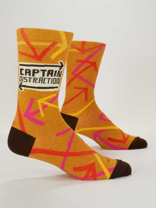 Blue Q Captain Distraction M-Crew Socks: orange combed cotton with pink and red arrows, dark brown toes and heels, and “Captain Distraction” in bold black text on one side.