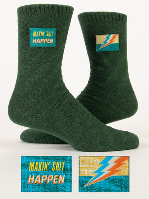 Blue Q’s Makin' Shit Happen Tag Socks feature green fabric, a bold “MAKIN’ SHIT HAPPEN” patch, and a colorful lightning bolt. Fits women’s shoe size 9–13 and men’s 8–12.
