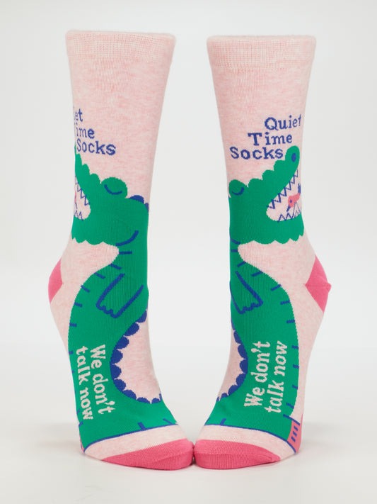 Blue Q Quiet Time Socks. We Don't Talk Now. W-Crew Socks: Pink women's crew socks with green cartoon alligators, "Quiet Time Socks" at the top, and "We don't talk now" along the foot, made from soft combed cotton.