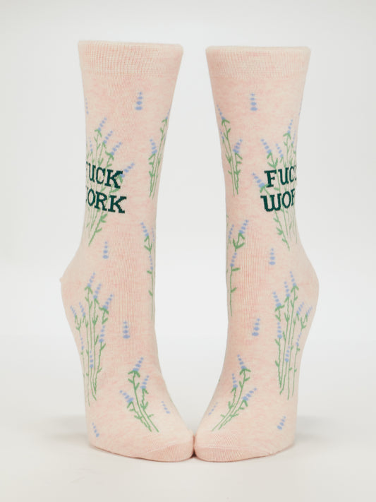 Add attitude to your style with Blue Q's Fuck Work Crew Socks—a pink cotton pair for women featuring green “FUCK WORK” text and a light purple flower pattern on a white background.