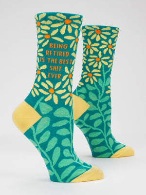 Blue Q’s Being Retired Is The Best Shit Ever W-Crew Socks feature two teal, combed cotton socks with yellow toes and heels, decorated with large yellow flowers and green leaves. Designed to fit women’s shoe sizes 5–10, these socks are completed with the playful text: Being retired is the best shit ever.