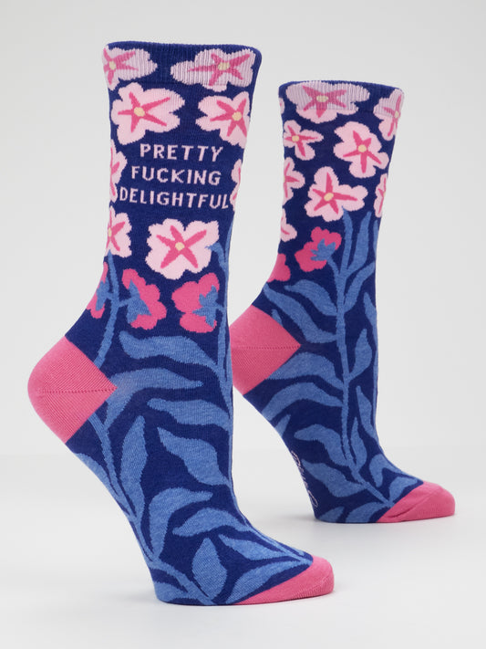 Step out in style with the Pretty Fucking Delightful W-Crew Socks by Blue Q. These women’s crew socks (shoe size 5-10) feature two blue combed cotton socks adorned with pink flowers, blue leaves, and pink heels and toes. One sock boldly displays “PRETTY FUCKING DELIGHTFUL” in pink lettering amid the floral design—bringing comfort and attitude together in every step.