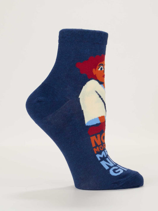 The No More Mr. Nice Girl Ankle Socks by Blue Q are blue women's combed cotton socks (shoe size 5-10), shown on a mannequin foot, with a red-haired cartoon and colorful partial text on the side.
