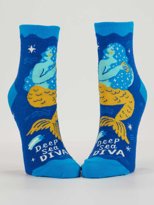 Deep Sea Diva Ankle Socks by Blue Q feature soft combed cotton, a yellow-tailed mermaid with blue hair and stars among sea motifs. "Deep Sea DIVA." text adds pop flair to any women's shoe collection.