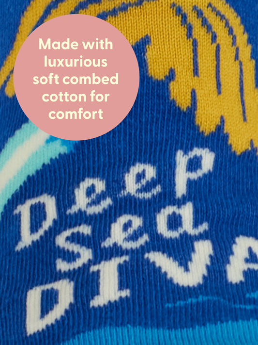 Close-up of blue and yellow knit fabric with "Deep Sea Diva," inspired by pop music. Features a pink circle: Made with luxurious soft combed cotton. Deep Sea Diva W-Ankle Socks by Blue Q.