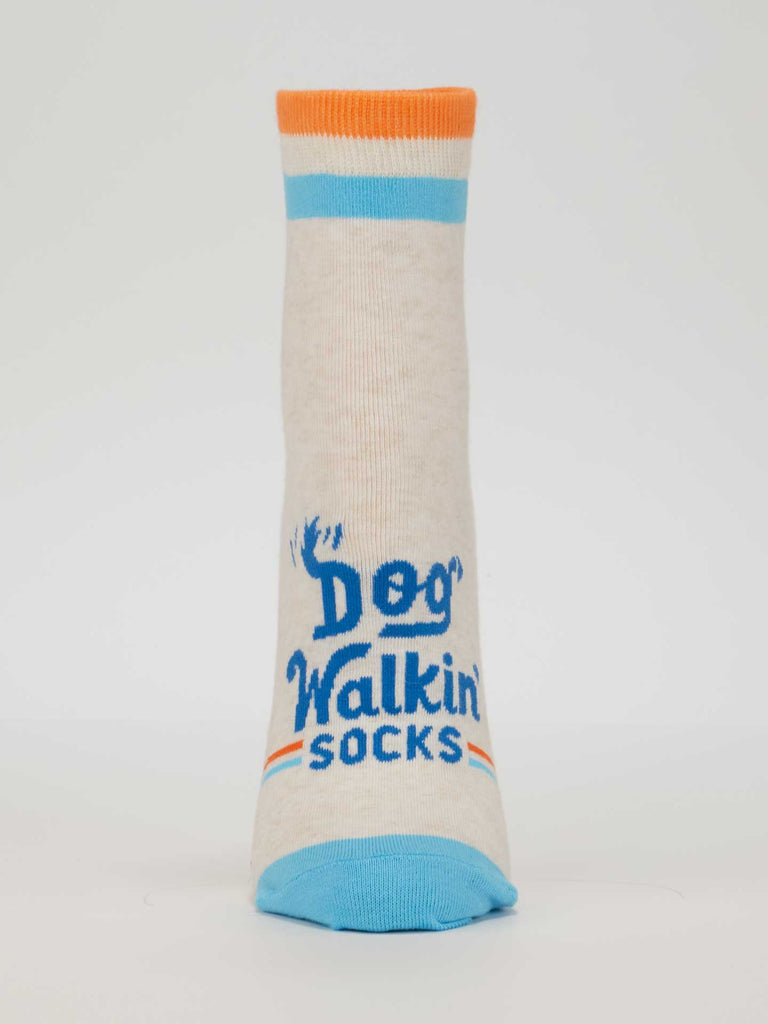 The Blue Q Dog Walkin' Ankle Socks are beige women's socks with blue toes and heels, orange and blue stripes at the top, and "Dog Walkin Socks" printed in blue—perfect comfy socks for your next stroll.