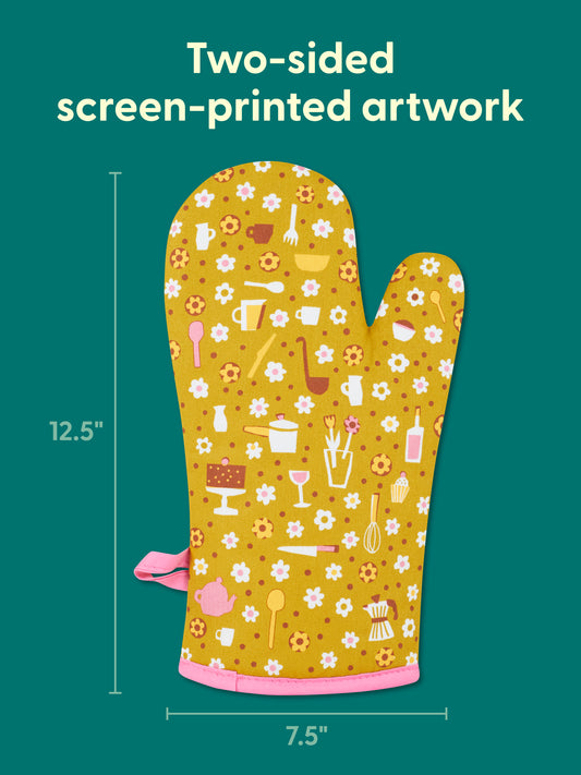 The Blue Q "No. I Will Never Want Your Help." Oven Mitt is yellow with pink trim, features two-sided screen-printed kitchen-themed artwork, made from 100% cotton, and measures 12.5" x 7.5".
