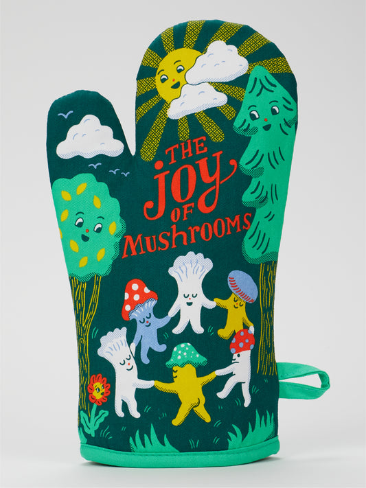 The Joy Of Mushrooms Oven Mitt by Blue Q is a super-insulated, 100% cotton green mitt featuring cheerful mushrooms, trees, a flower, and sun, with "The Joy of Mushrooms" text in bright, playful letters.