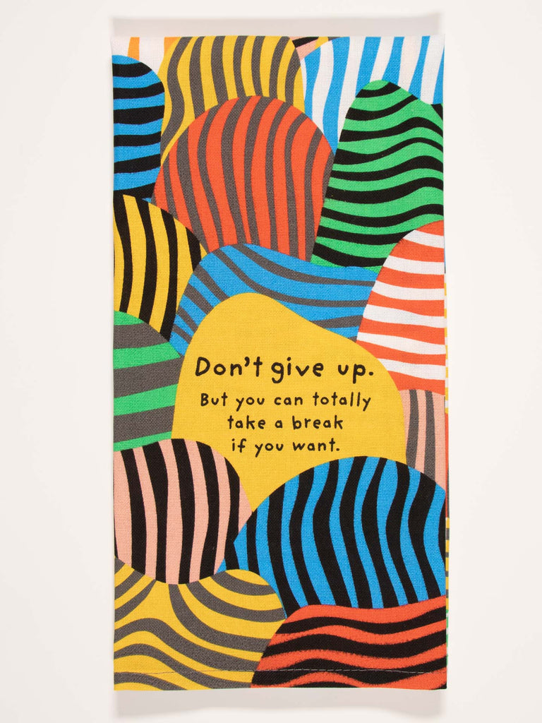 The Blue Q Take A Break Sale Pack includes a colorful dish towel with wavy stripes and a yellow center that reads: Don't give up. But you can totally take a break if you want—a cheerful gift bundle addition.