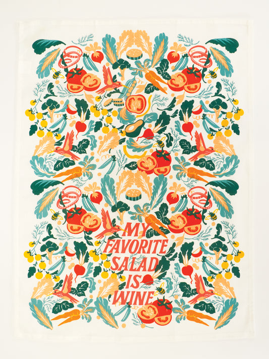 Blue Q’s “My Favorite Salad Is Wine Dish Towel” features a vibrant design of veggies, herbs, and fruits around bold red and yellow text on super-absorbent unbleached cotton.