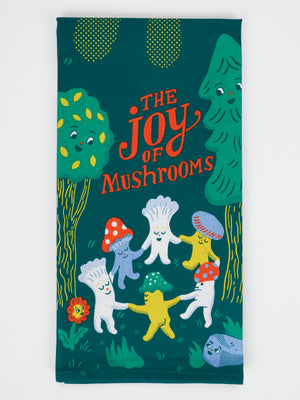 The Joy Of Mushrooms Dish Towel by Blue Q is a colorful tea towel made from super-absorbent, unbleached cotton. It features cheerful cartoon mushrooms holding hands in a ring and smiling, surrounded by trees, with "The Joy of Mushrooms" playfully written in red and yellow letters at the top.