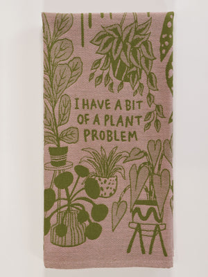 The Blue Q "I Have A Bit Of A Plant Problem" Dish Towel features green potted plant illustrations and bold text on a pink background—an ideal, charming accent for your kitchen or home decor.
