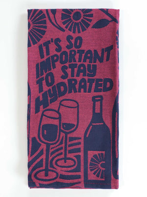 The Blue Q “It’s So Important To Stay Hydrated Dish Towel” features playful wine bottle and glass illustrations with its amusing hydration reminder in burgundy and navy.